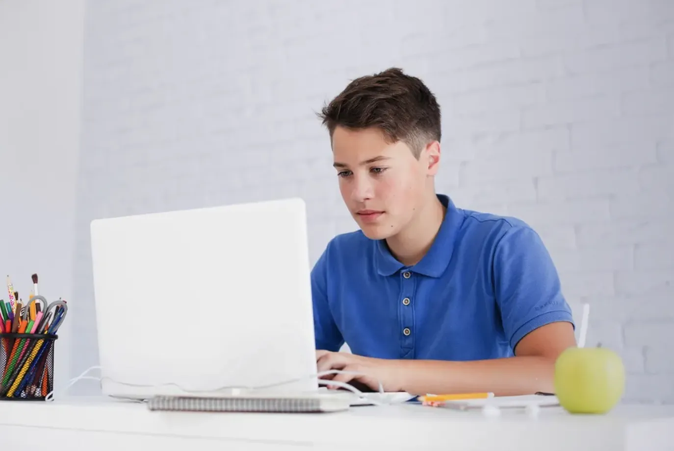 A learner working through a lesson on a laptop at home